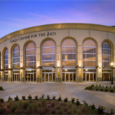 Gale Center for the Arts Modesto with arched windows, columns, and sunset sky